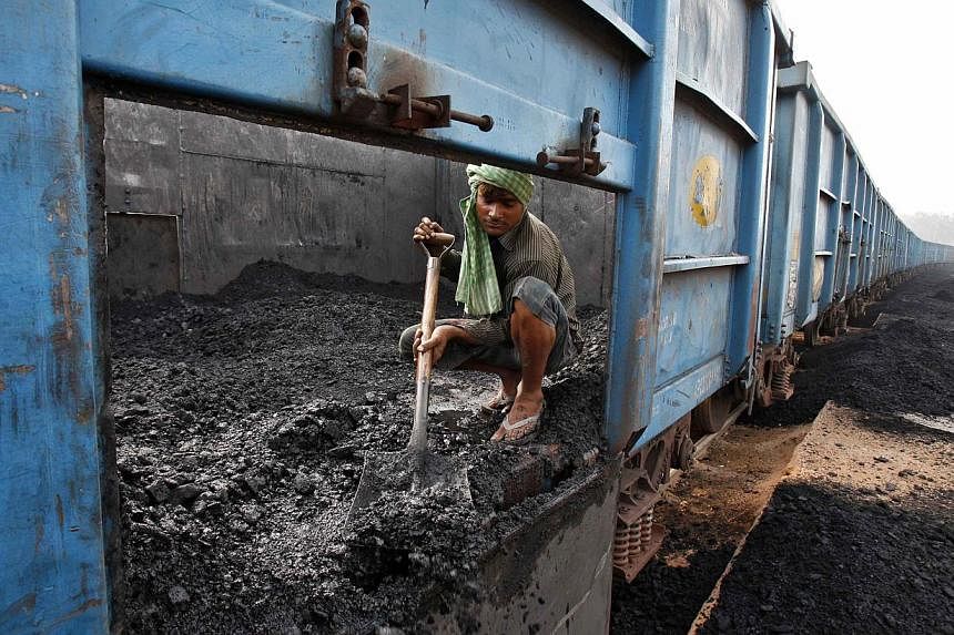 A worker unloads coal from a goods train at a railway yard in the northern Indian city of Chandigarh in this July 8, 2014, file photo.&nbsp;-- PHOTO: REUTERS