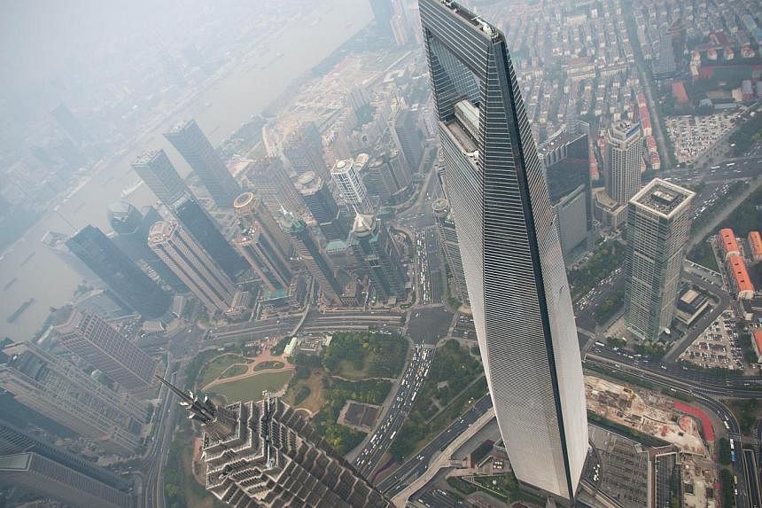 A general view shows the Shanghai World Financial Center and the skyline of the Lujiazui Financial District in Pudong, Shanghai on Oct 16, 2014. China's economy grew 7.3 per cent in the third quarter from a year earlier, a five year for the world's s