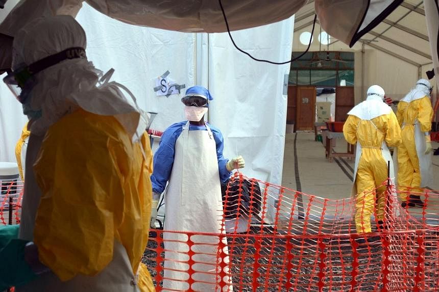 Liberian health workers are seen at the NGO Medecins Sans Frontieres (Doctors Without Borders) Ebola treatment center in Monrovia on Oct 18, 2014.&nbsp;The World Health Organisation's (WHO) emergency committee on Ebola will meet on Wednesday to revie