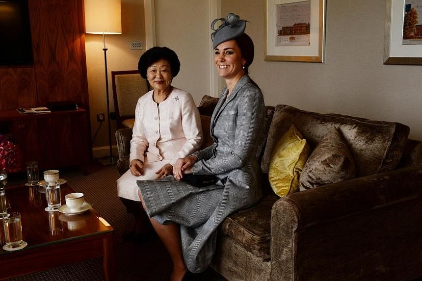 Britain's Catherine, Duchess of Cambridge (right), sits with Mary Tan (left), wife of Singapore's President Tony Tan Keng Yam, at the Royal Garden Hotel in London on Oct 21, 2014, ahead of the official ceremonial welcome at the start of the Singapore