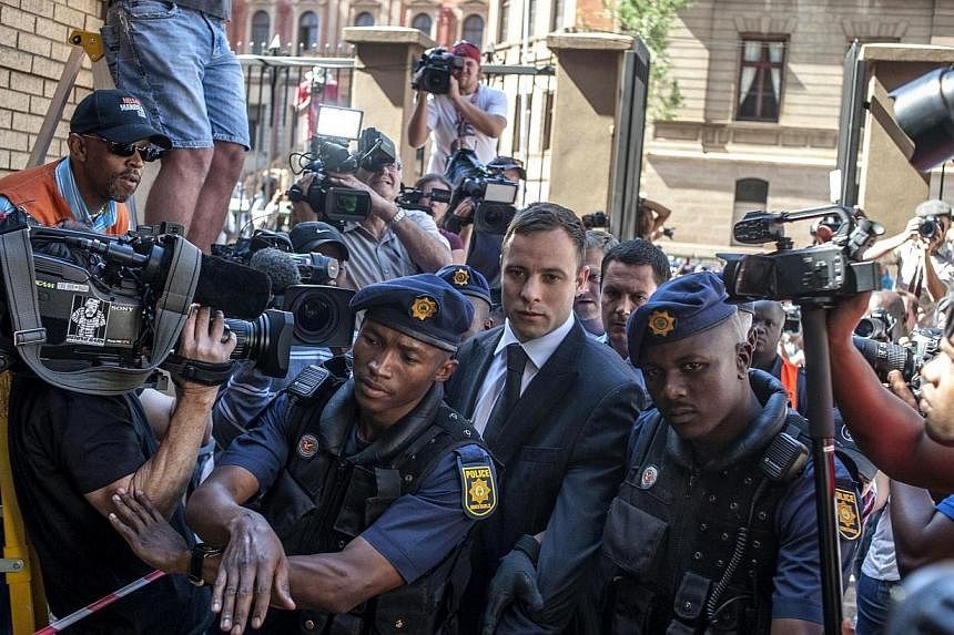 South African Paralympic athlete Oscar Pistorius arrives at the High Court in Pretoria on Oct 21, 2014. -- PHOTO: AFP