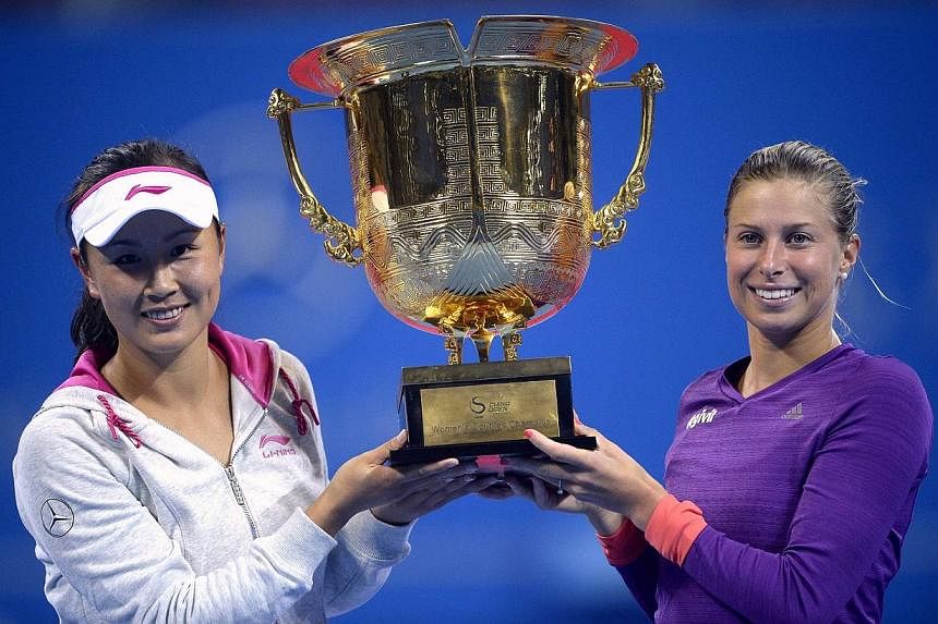 Peng Shuai (left) of China and her partner Andrea Hlavackova of Czech Republic pose with the trophy after winning their women's doubles final match at the China Open Tennis Tournament, in Beijing on Oct 4, 2014.&nbsp;Peng said her new doubles partner