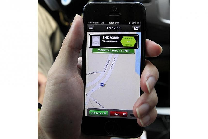 The GrabTaxi app on a smartphone. GrabTaxi is a third-party taxi booking application which commuters can download onto their phones. -- PHOTO: ST FILE