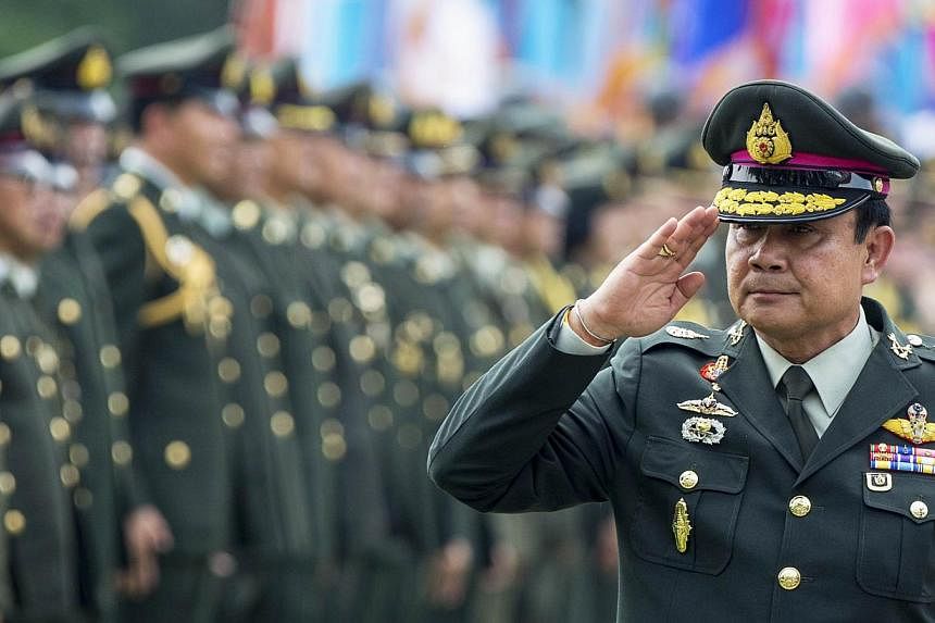 Thailand's Prime Minister Prayuth Chan-ocha salutes members of the Royal Thai Army after a handover ceremony for the new Royal Thai Army Chief, General Udomdej Sitabutr, at the Thai Army Headquarters in Bangkok on Sept 30, 2014.&nbsp;A council select