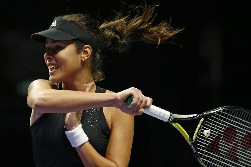 Ana Ivanovic of Serbia hits a return to Eugenie Bouchard of Canada during their WTA Finals singles tennis match at the Singapore Indoor Stadium on Oct 22, 2014.&nbsp;-- PHOTO: REUTERS
