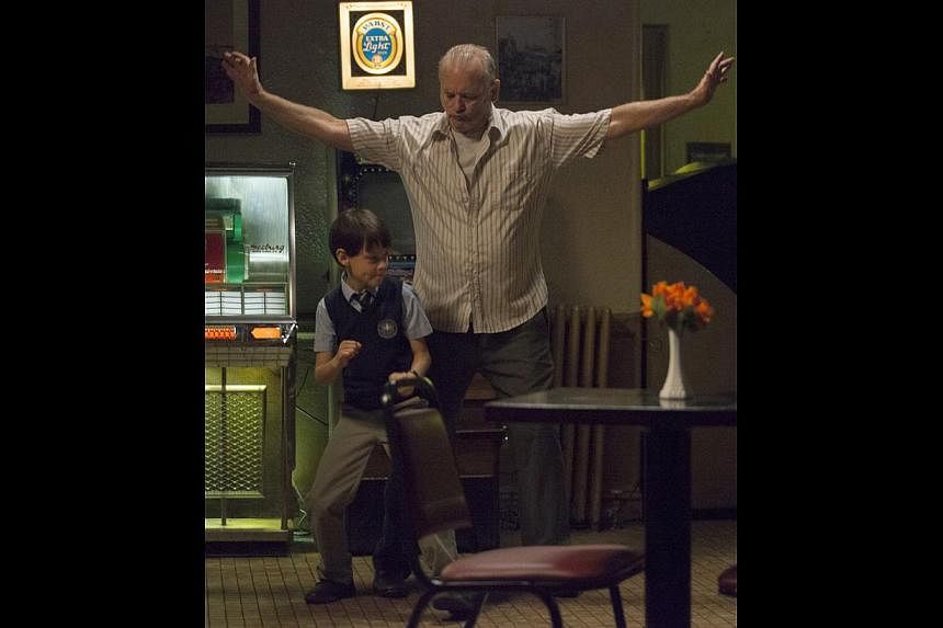 Bill Murray plays Vincent, who babysits a 12-year-old (Jaeden Lieberher, both above) to pay off his gambling debts.