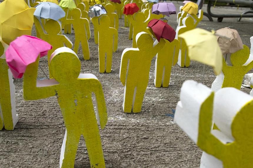 An art installation made from wood and paper depict the scene of Occupy Central protesters holding up their umbrellas outside the government headquarters in Hong Kong on Oct 20, 2014. -- PHOTO: REUTERS