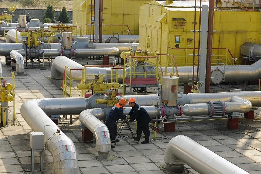Employees at work near an underground gas storage in the village of Opari, some 70 kms south-west from Lviv. Ukraine must pay $3.9 billion if it wants Moscow to resume supplies of natural gas, Russia's Energy Minister Alexander Novak said today. -- P