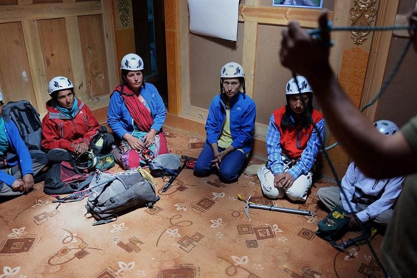 In this photograph taken on August 4, 2014, Pakistani students take part in a lesson at the Shimshal Mountaineering School in Shimshal village in the northern Hunza valley. Breaking taboos and pursuing jobs traditionally done by men, the first batch 