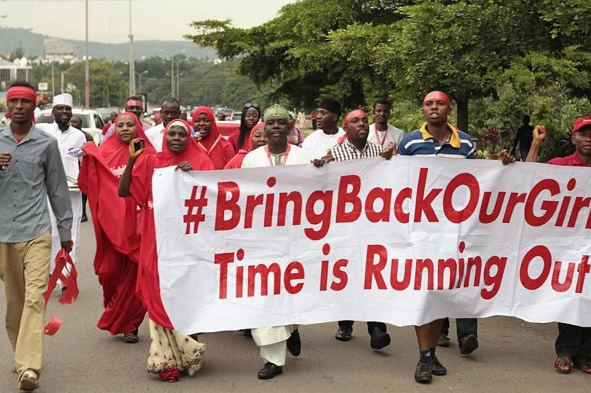 Campaigners from "#Bring Back Our Girls" march during a rally calling for the release of the Abuja school girls who were abducted by Boko Haram militants, in Abuja on Oct 17, 2014.&nbsp;The Nigerian schoolgirls kidnapped by Boko Haram Islamists will 