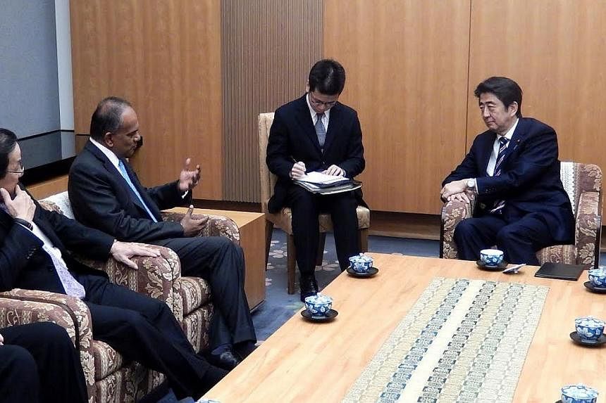 Minister K Shanmugam (second, left) calling on Japanese Prime Minister Shinzo Abe (right). -- PHOTO: MINISTRY OF FOREIGN AFFAIRS