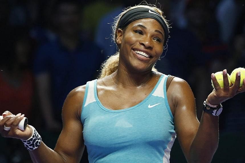 Serena Williams of the U.S. smiles to the crowd after defeating Eugenie Bouchard of Canada during their WTA Finals singles tennis match at the Singapore Indoor Stadium on Oct 23, 2014.&nbsp;One day after suffering her heaviest defeat since she was a 