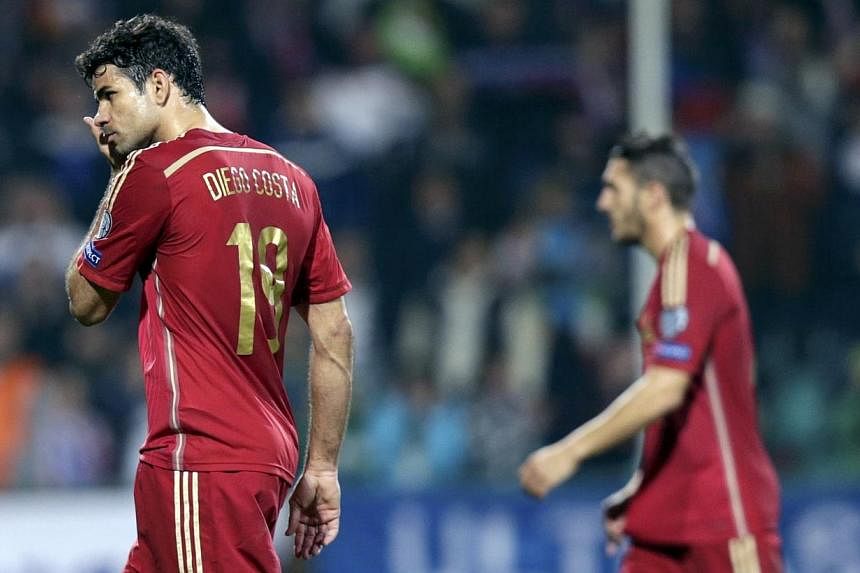 Diego Costa of Spain (left) leaves the pitch after their Euro 2016 qualification loss against Slovakia at the MSK stadium in Zilina Oct 9, 2014. &nbsp;-- PHOTO: REUTERS