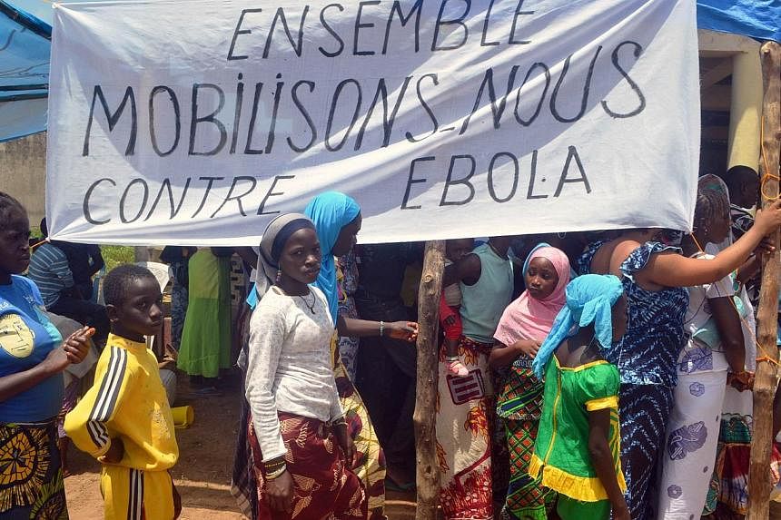 Residents attend an awareness campaign on Ebola by local authorities in western Guinea. The families of every Guinean health worker who has died in the Ebola outbreak will be compensated for their loss with US$10,000, the government said on Oct 22. -