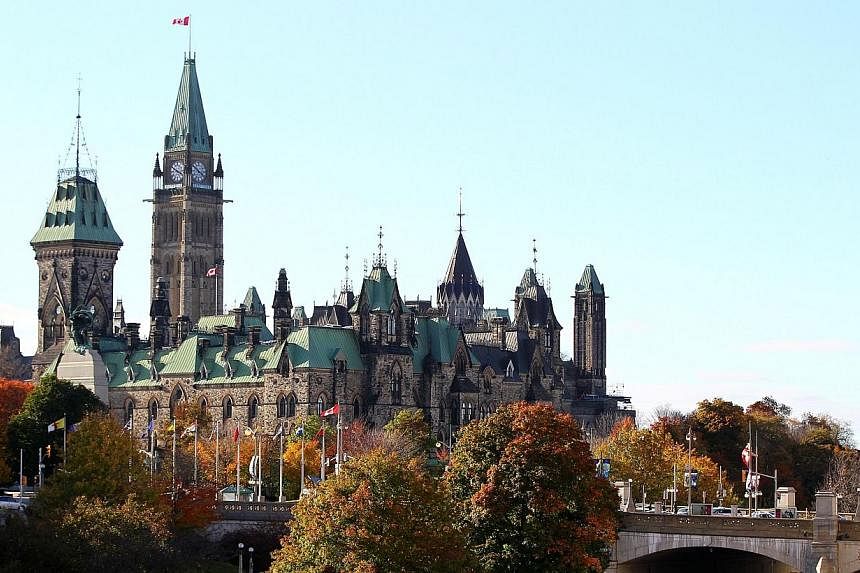The Canadian government determined to return to business as usual on Thursday after a reported convert to Islam shot dead a soldier at the National War Memorial and rampaged through Parliament before being killed himself. -- PHOTO: AFP