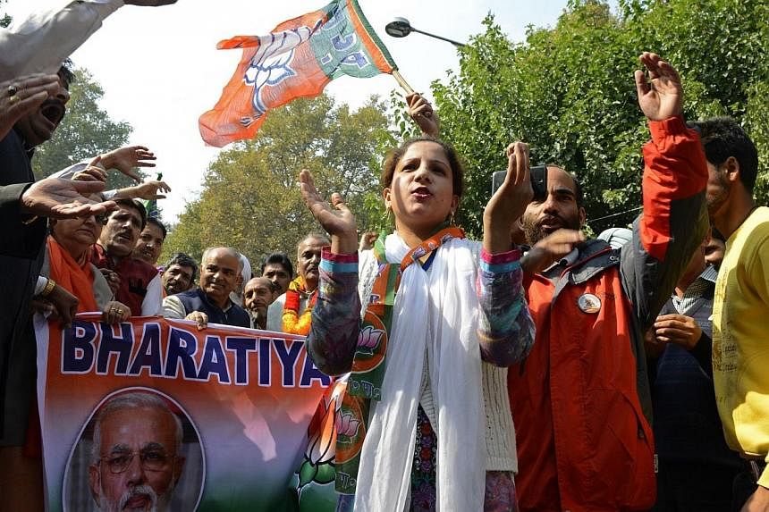 Hindu nationalist Bharatiya Janata Party supporters gesture as they march towards Governor House, where Indian Prime Minister Narendra Modi is scheduled to meet with some flood-affected Kashmiris, in Srinagar on Oct 23, 2014.&nbsp;Indian Prime Minist