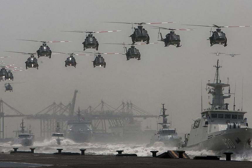 Indonesian helicopters and navy ships in formation at an event earlier this month. President Joko promised during his campaign to have a maritime policy that safeguards Indonesia's economy and defence.