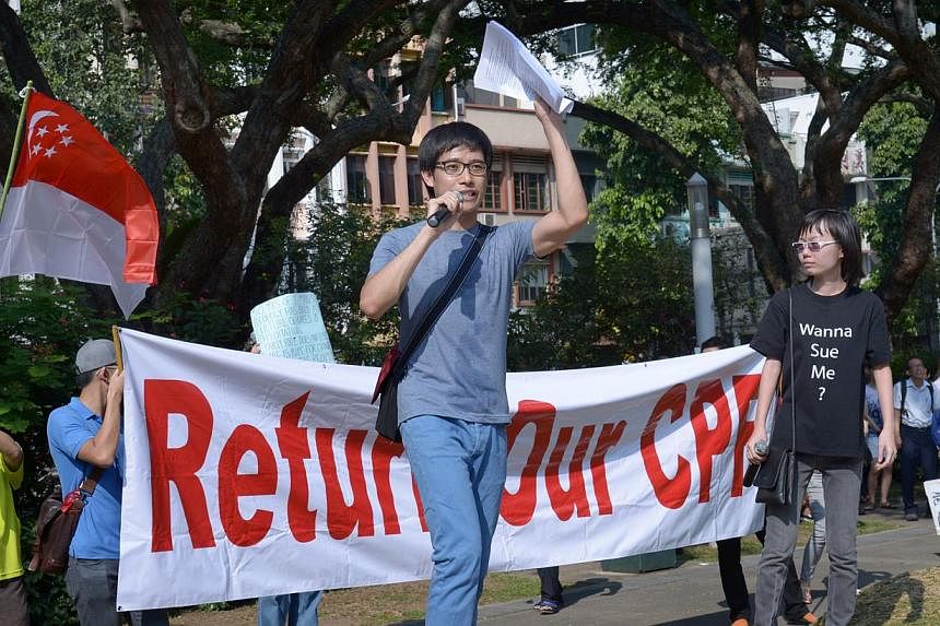 Roy Ngerng (centre) and Han Hui Hui (right) speaking at the Return Our CPF rally at Hong Lim Park on Sept 27, 2014. -- PHOTO: ST FILE&nbsp;