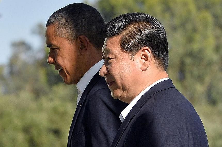 A June 7, 2013 file photo shows US President Barack Obama (left) and Chinese President Xi Jinping heading for a bilateral meeting at the Annenberg Retreat at Sunnylands in Rancho Mirage, California. -- PHOTO: AFP&nbsp;