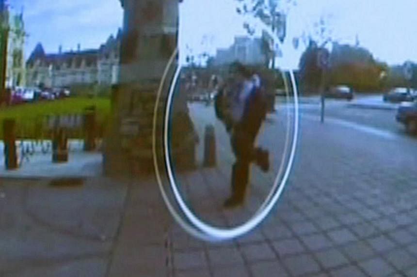 A man identified by Royal Canadian Mounted Police as Michael Zehaf-Bibeau is seen on Oct 22, 2014 as he exits a car and runs toward the Parliament buildings in a still image taken from surveillance video released by the RCMP Oct 23, 2014. -- PHOTO: R