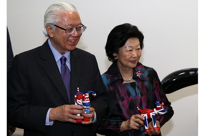 Singapore's President Tony Tan Keng Yam (left) and his wife Mary Tan hold momentos after a visit to film production company Aardman Animatons at their head office in Bristol on Oct 23, 2014. -- PHOTO: AFP