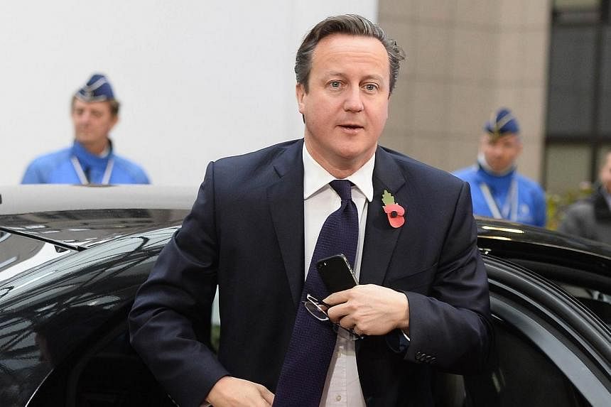 British Prime Minister David Cameron arrives for a European Union summit at the EU headquarters in Brussels on Oct 24, 2014. -- PHOTO: AFP