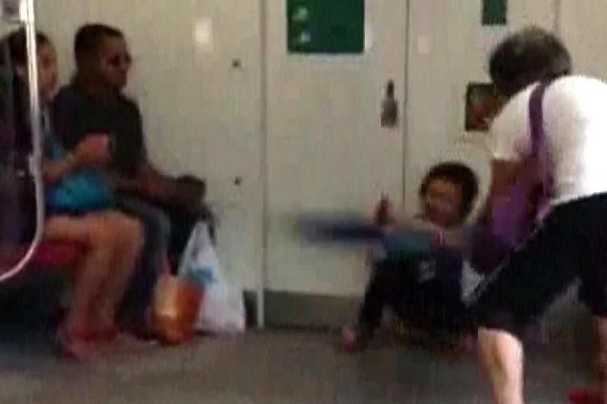 An 11-second video posted on citizen journalism portal, Stomp, shows an elderly woman in her 60s beating a child who appeared to be about nine years old, repeatedly with an umbrella at the end carriage of a MRT train at about 5.30pm on Oct 22, 2014. 