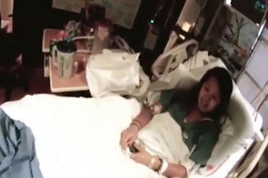 This frame grab from a video courtesy of Texas Health Resources, Nurse Nina Pham lies on her hospital bed on Oct 16, 2014, at Texas Health Presbyterian Hospital in Dallas, Texas.&nbsp;An American nurse who contracted Ebola while caring for a Liberian