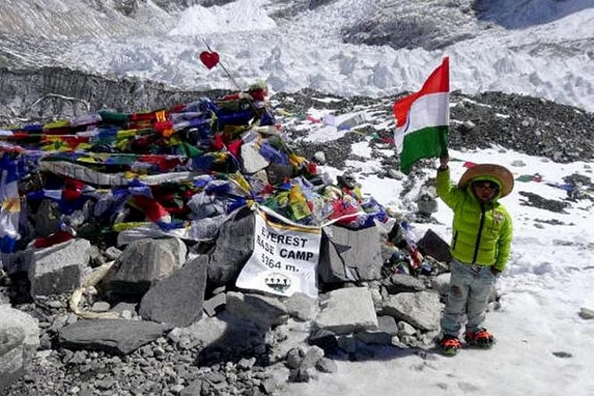 Five-year-old Harshit Saumitra waving the Indian flag at the Everest Base Camp.The New Delhi schoolboy took 10 days to complete the 62km trek to the base camp located 5,364m above sea level. -- PHOTO: HINDUSTAN TIMES