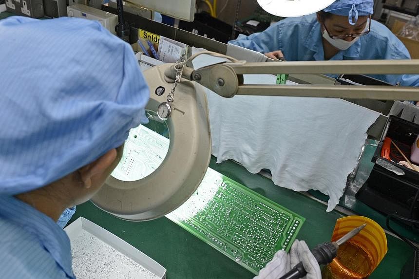 Workers at Add-Plus, an electronics manufacturing company that makes printed circuit boards.&nbsp;Manufacturing output here contracted 1.2 per cent in September from the same month a year ago, mainly due to a sharp drop in biomedical production, the 