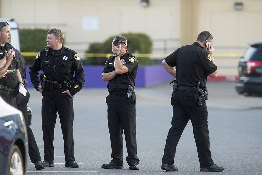 Sacramento County Sheriff Lieutenant Palmer covers his face while gathered with fellow officers near a Motel 6 parking lot where Sheriff's Deputy Danny Oliver was killed in Sacramento, California on Oct 24, 2014.&nbsp;