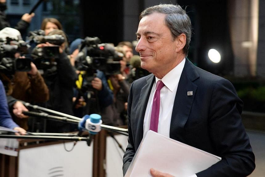 President of the European Central Bank (ECB) Mario Draghi arrives on the second day of the European Union summit at the EU headquarters in Brussels on Oct 24, 2014. -- PHOTO: AFP