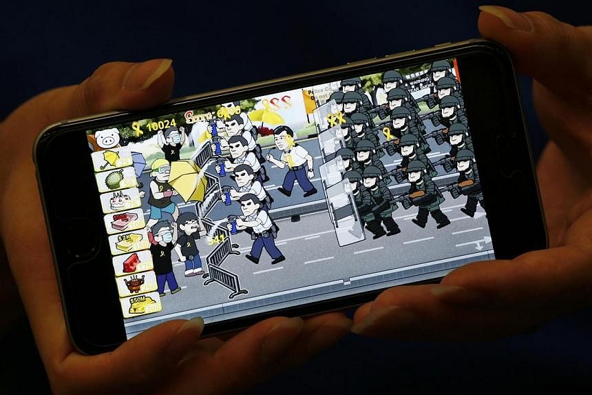 A scene from the Yellow Umbrella game, depicting riot police and pro-democracy protesters, is shown at the office of game developer Fung Kam Keung in Hong Kong, on Oct 23, 2014. -- PHOTO: REUTERS