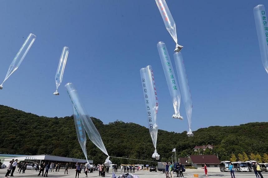 Balloons containing anti-North Korean leaflets are released by former North Korean defectors near the demilitarized zone in Paju on Oct 10, 2014. -- PHOTO: REUTERS