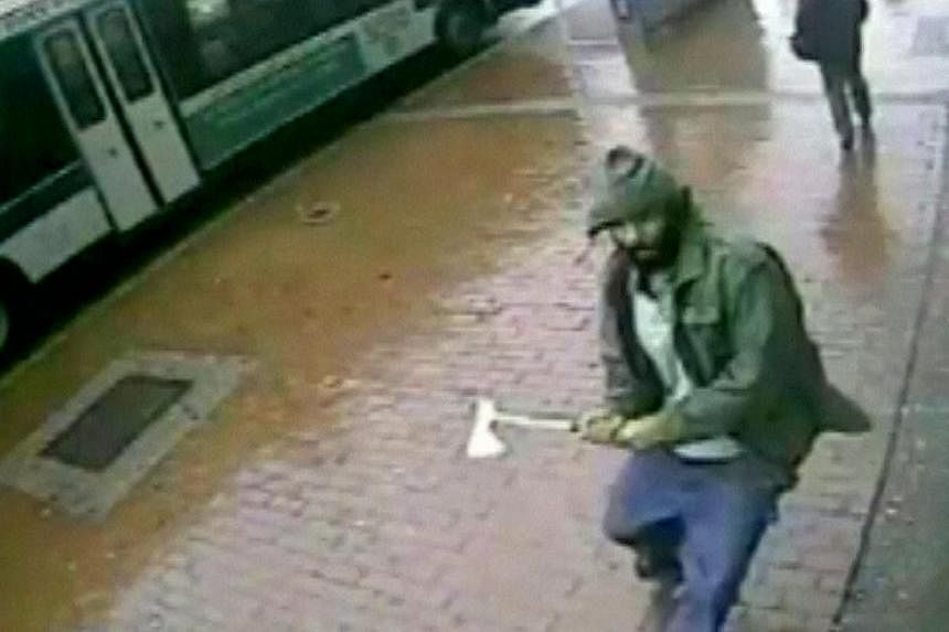A man holding a hatchet is seen in a still image from surveillance video provided by the New York Police Department on Oct 23, 2014. -- PHOTO: REUTERS