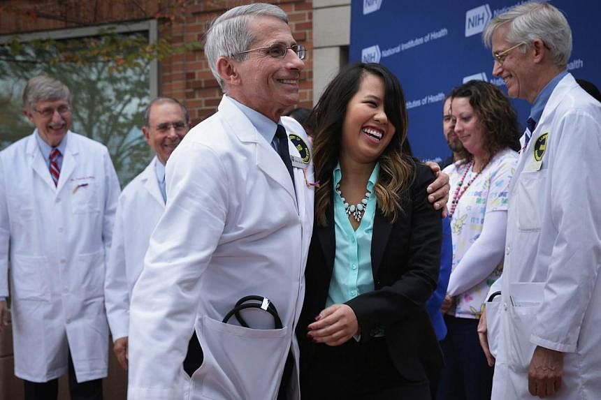 Director of the National Institute of Allergy and Infectious Diseases Anthony Fauci (third left) leaves with Nina Pham (forth left), the nurse who was infected with Ebola from treating patient Thomas Eric Duncan, as Director of the National Institute