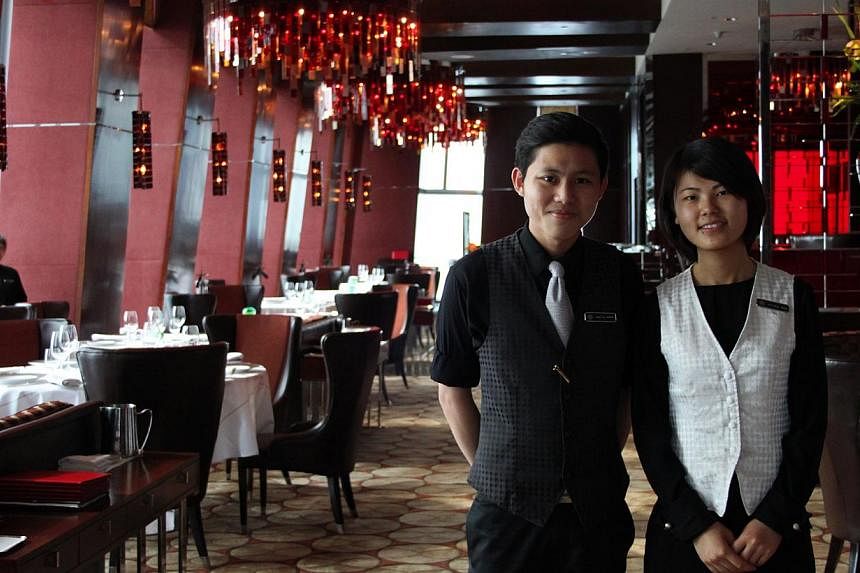 Mr Ryan Tan, who graduated this year from Republic Polytechnic, completed a six-month internship last year in Shangri-La Hotel in Beijing. He is seen here at the hotel with full-time waitress Rita Zheng.