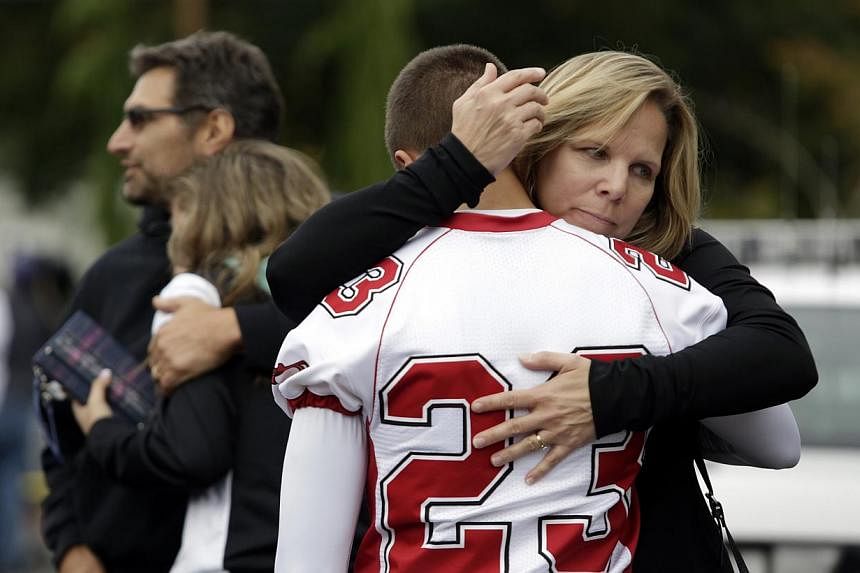 Students and family members reunite at Shoultes Gospel Hall after a student opened fire at Marysville-Pilchuck High School, in Marysville, Washington on Oct 24, 2014. -- PHOTO: REUTERS