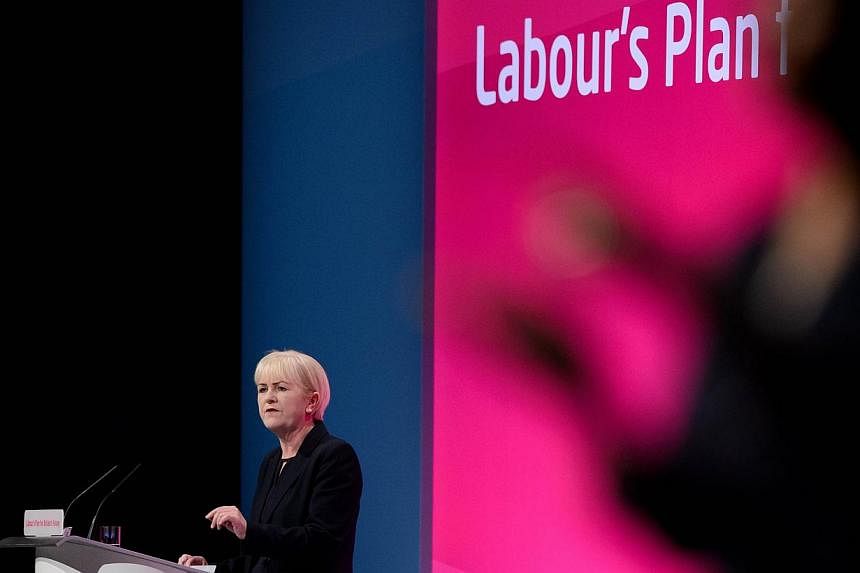 A sign language interpreter signs as Scottish labour party leader Johann Lamont speaks to delegates at the conclusion of the Scotland Report in the main hall of Manchester Central, in Manchester on Sept 22, 2014 on the second day of the Labour Party 