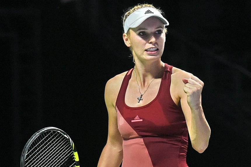 Caroline Wozniacki reacts to a point against&nbsp;Serena Williams during the semi-finals of the WTA Finals in Singapore on Oct 25, 2014. -- PHOTO: AFP