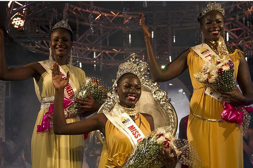 Leah Kalanguka (centre), newly elected Miss Uganda, poses for a picture with 1st runner up Brenda Iriama (left) and 2nd runner up Yasmin Taban (right) in Kampala on Oct 26, 2014. -- PHOTO: AFP