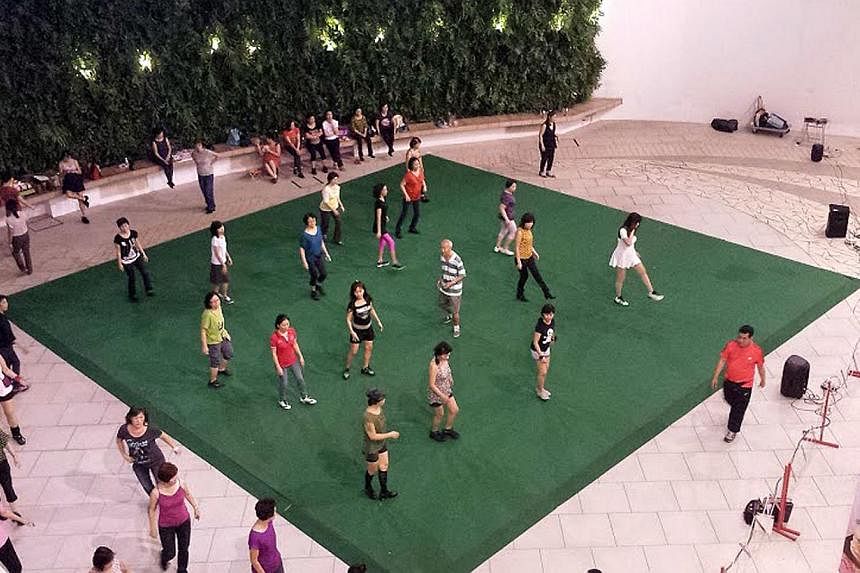 Malls are hosting free fitness classes such as yoga sessions at The Star Vista and line dancing at City Square Mall (above). -- PHOTO: YIPEE