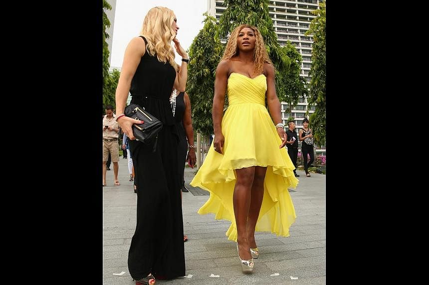 Serena Williams (right), seen here with Caroline Wozniacki, can capture the WTA Finals crown today. She says her stay in Singapore has been an eye-opener and she will be back in December for the International Premier Tennis League.