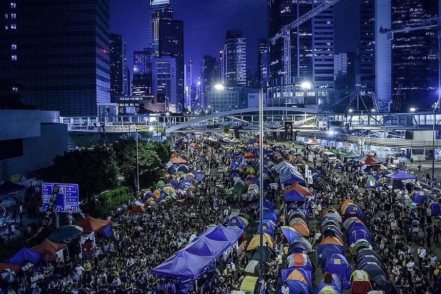 Pro-democracy protester gather at the main protest site in the Admiralty district of Hong Kong on Oct 24, 2014. -- PHOTO: AFP