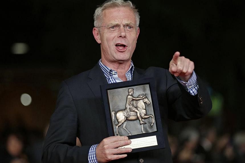 British director Stephen Daldry holds the BNL People Choice award for his movie "Trash" at the Rome Film Festival, on Oct 25, 2014. -- PHOTO: REUTERS