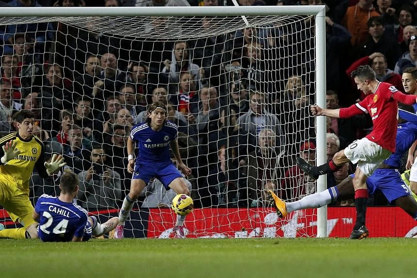 Manchester United's Robin van Persie shoots to score during their English Premier League soccer match against Chelsea at Old Trafford. -- PHOTO: REUTERS&nbsp;
