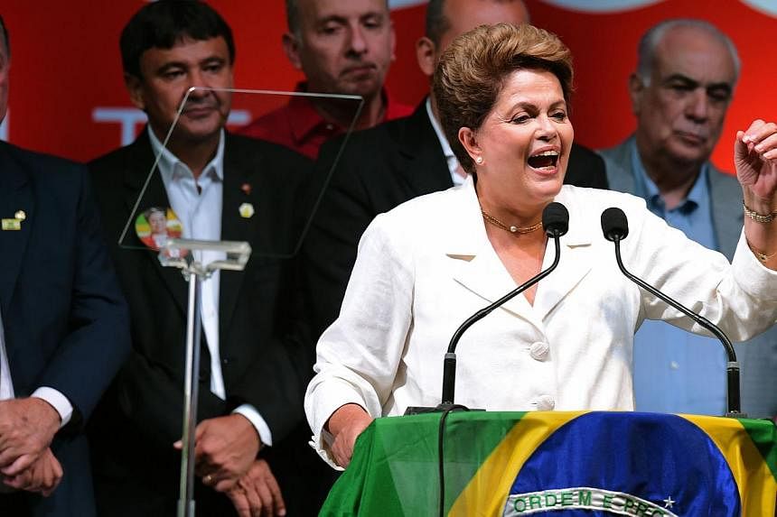 Re-elected Brazilian President Dilma Rousseff delivers a speech following her win, in Brasilia on Oct 26, 2014. -- PHOTO: AFP