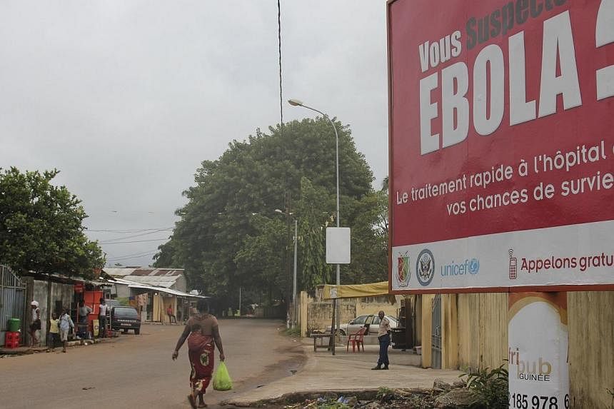 A billboard with a message about Ebola is seen on a street in Conakry, Guinea on Oct 26, 2014.&nbsp;Australia said Monday it was suspending migration from Ebola-hit West African nations to try to prevent the virus from crossing its borders, as a teen