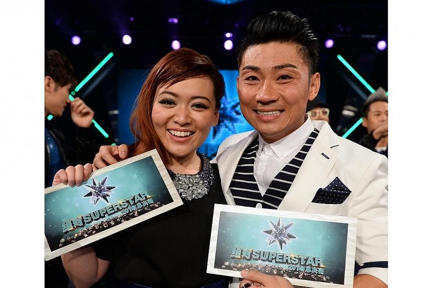 Athletics coach Alfred Sim (right), 33, beat polytechnic student Abigail Yeo (left), 19 to win local Mandarin singing competition Project Superstar on Sunday night. -- PHOTO:&nbsp;MEDIACORP CHANNEL U