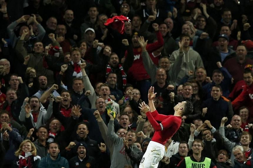 Manchester United's Robin van Persie celebrates after scoring during their English Premier League football match against Chelsea at Old Trafford in Manchester, northern England on Oct 26, 2014. -- PHOTO: REUTERS